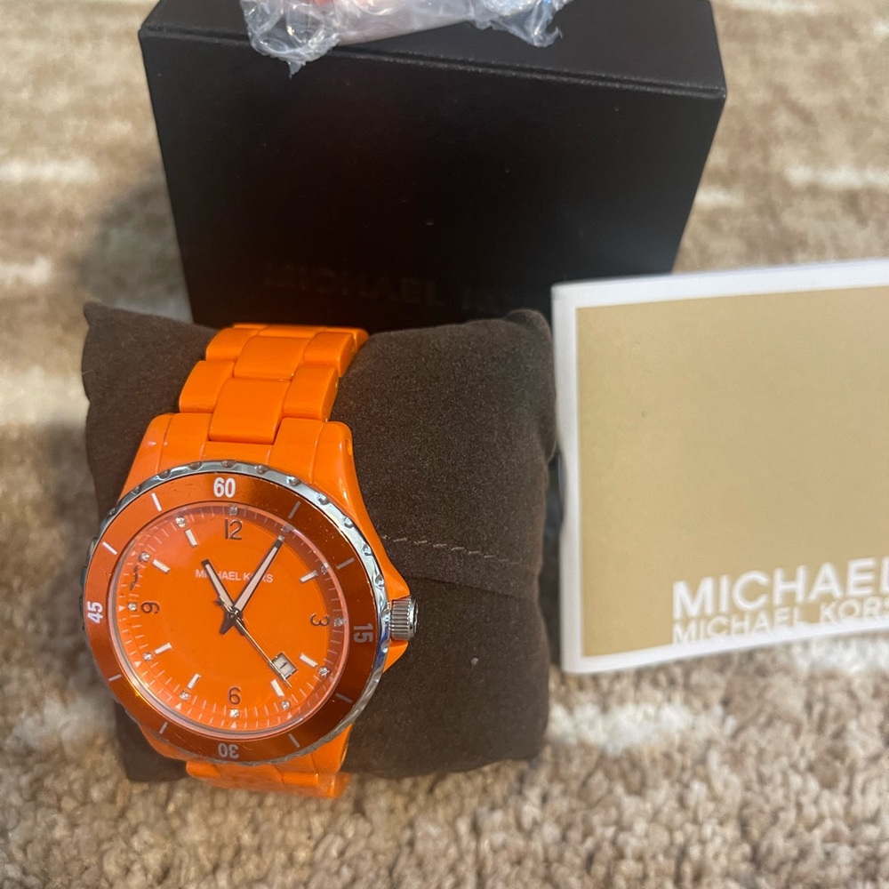 Michael kors orange and silver watch. Like new. Needs a new battery.